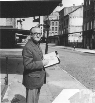 photograph of Depol with sketchbook on sidewalk