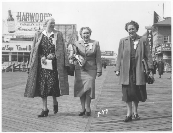 3 women walking on boardwalk