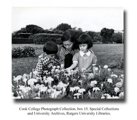 Woman and two children in field with flowers. Cook College Photograph Collection, box 15. Special Collections and University Archives, Rutgers University Libraries.